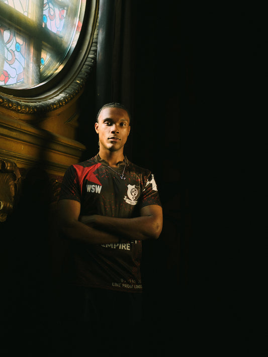 Hackney Women's FC player in the black Hackney Empire jersey, showing the Playing with Pride Since 1986 badge